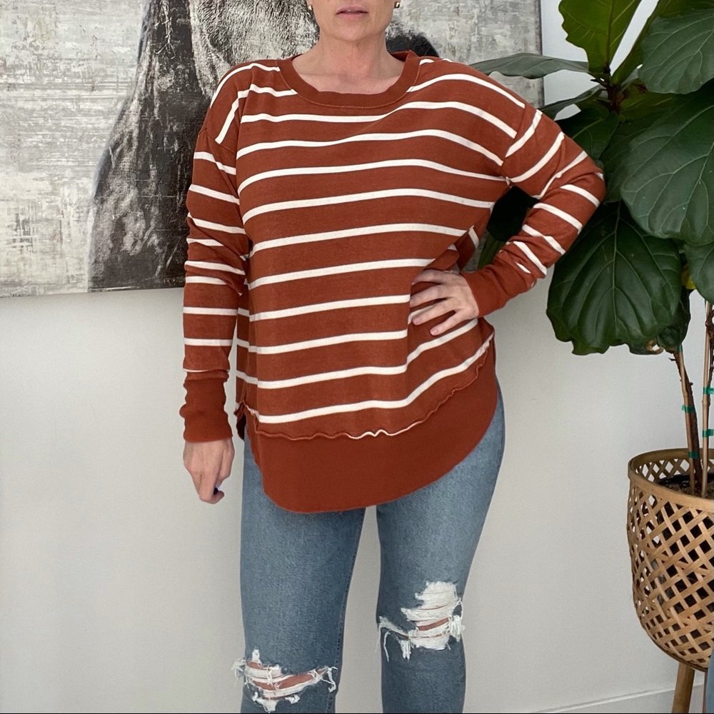 Rust color tunic sweatshirt with thumb holes.